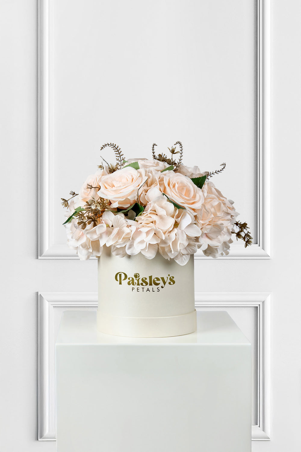 Floral arrangement in a white box with 'Paisley's Petals' branding on a white background
